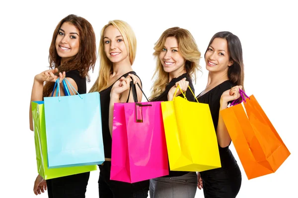 Cuatro chicas con bolsas de compras por encima de su hombro —  Fotos de Stock