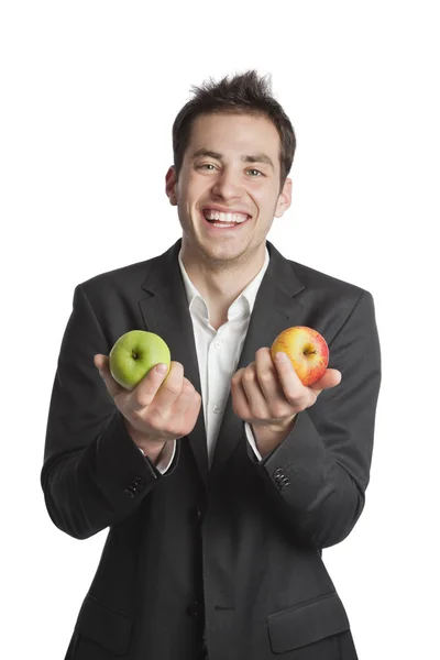 Jungprofi mit zwei Äpfeln Stockbild