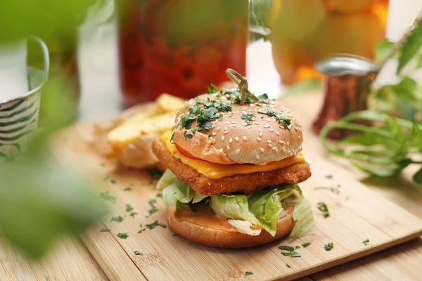 Veganistische hamburger en aardappelfrietjes op een houten snijplank, selectieve focus. Plantaardige maaltijd, vegetarische lunch, horizontaal uitzicht. Rechtenvrije Stockafbeeldingen