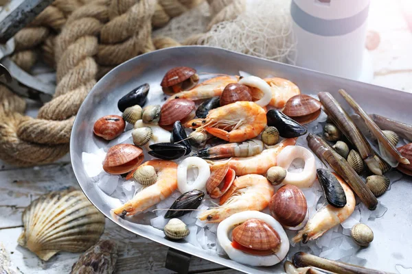 Mediterranean, varied raw seafood mix on a metal plate, tray, top view. Marine composition, selective focus. Fish shop assortment, seafood concept.