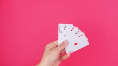 Kumarbaz el kumarda beş çeşit poker kartı. Düşen paralar, pembe arka plan. Şanslı birleşim Aces ve Joker ortaya çıkıyor. Çevrimiçi kumarhane kumarhanesi. Kazanan bahis konsepti Entertainment