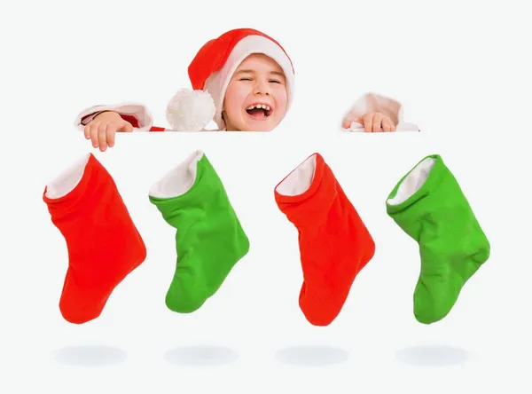 Un niño alegre en un traje de Santa Claus y botas de Navidad. —  Fotos de Stock