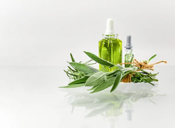 Bundle with herbs and bottles with extracts. Oil alcohol and water. — Stock Photo, Image