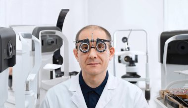 Tıbbi teşhis ekipmanlarının arka planına karşı gözlük çerçevesinde oftalmolog.