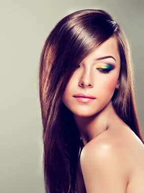 Brunette with long hair and modern make-up clipart
