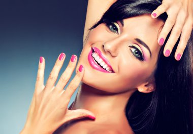 Brunette woman showing her manicure