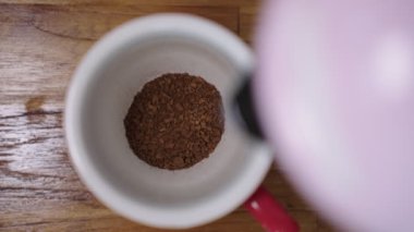 UHD 4k Yavaş Hareketi, sıcak suyu kırmızı kahve bardağına döküyor. Kahvenin üstüne dökülen taze sabah görüntüsü. İnsanlar sabahları sıcak espresso yapıyor..