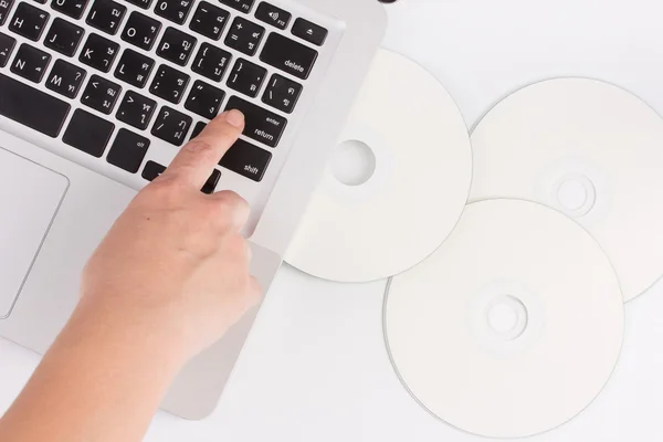 Laptop e disco compacto com mão — Fotografia de Stock