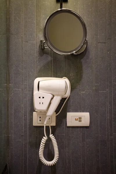 Hair dryer and mirror in the bathroom — Stock Photo, Image