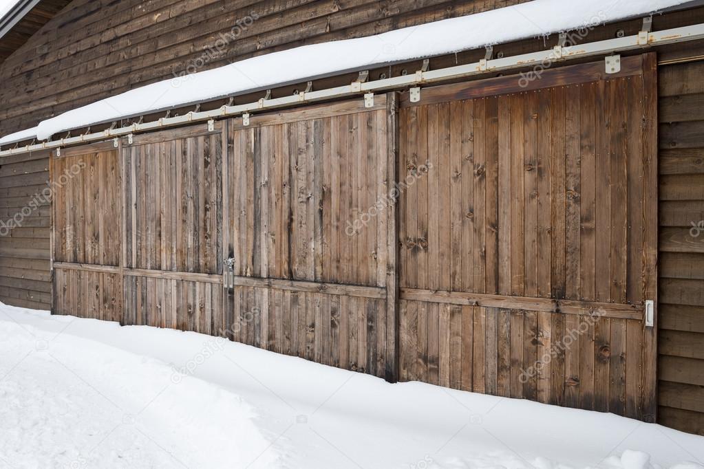 Old wooden barn door with snow