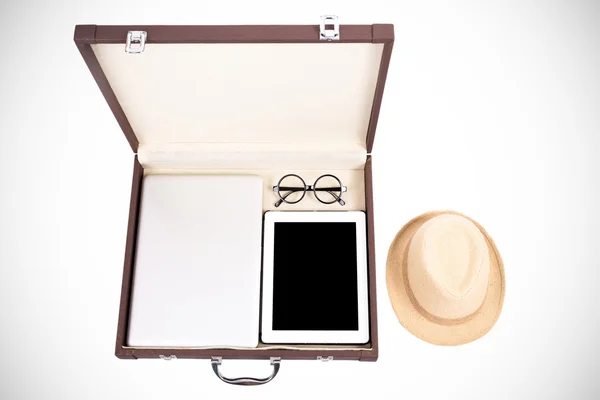 Blank tablet, laptop glasses and hat in briefcase on white (filt — Stock Photo, Image