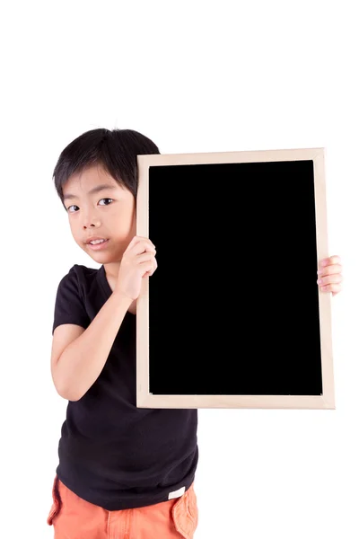 Sonriente niño sosteniendo una pizarra sobre fondo blanco — Foto de Stock