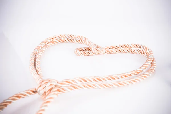 Orange rope in heart shape with vignette — Stock Photo, Image