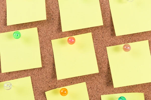 Yellow reminder sticky note on cork board, empty space for text — Stock Photo, Image