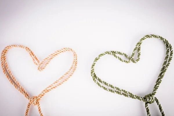 Orange and green rope in heart shape with vignette — Stock Photo, Image