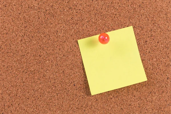 Yellow reminder sticky note on cork board, empty space for text — Stock Photo, Image