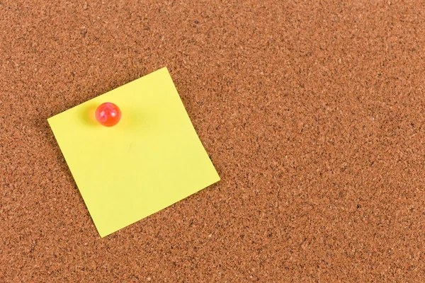 Yellow reminder sticky note on cork board, empty space for text — Stock Photo, Image
