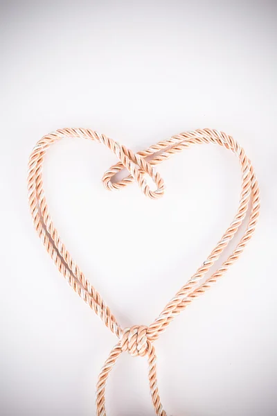 Orange rope in heart shape with vignette — Stock Photo, Image