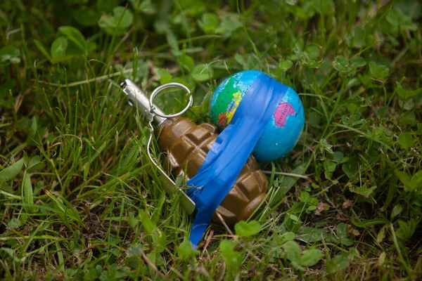 Planet Earth rewound with duct tape to a grenade