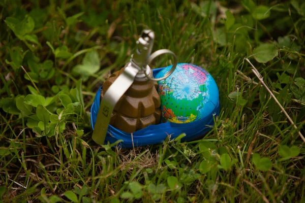 Planet Earth rewound with duct tape to a grenade