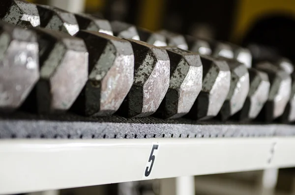 Dumbbells sitting on a rack — Stock Photo, Image