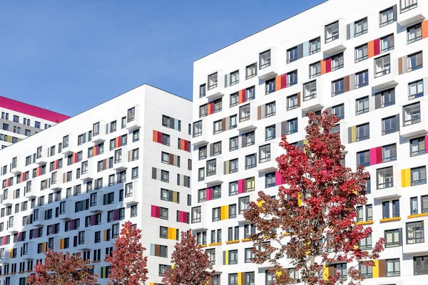 Multi-colored residential skyscrapers against the blue sky. Dense urban development in a big city. Modern urban housing