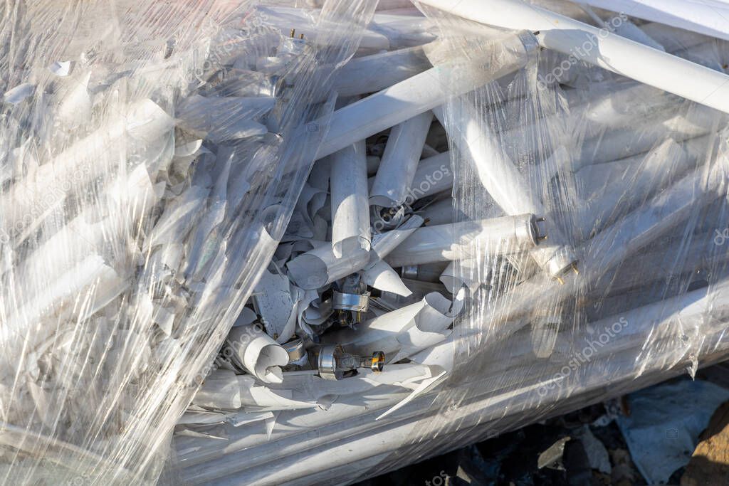 Bolsa de plástico con muchas lámparas fluorescentes rotas. Vertedero