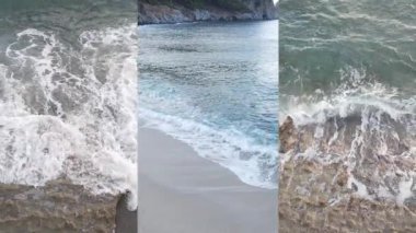 Deniz kıyısının yakınındaki deniz suyunun dikey bir videosunda üç kişi, yavaş çekim.