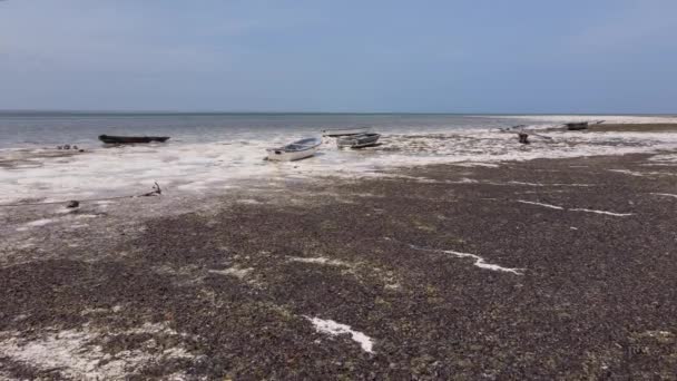 Aerial view of low tide in the ocean near the coast of Zanzibar, Tanzania, slow motion — Stock Video