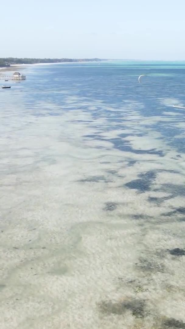 Vertical video kitesurfing near the shore of Zanzibar, Tanzania, aerial view — Stock Video