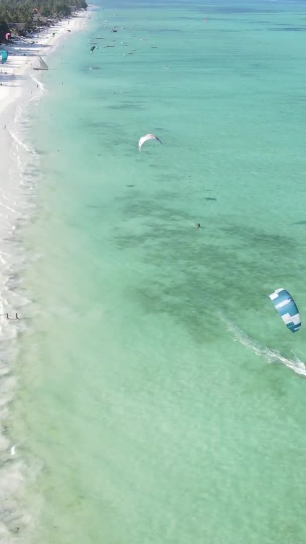 Vertical video kitesurfing near the shore of Zanzibar, Tanzania, aerial view — Stock Video