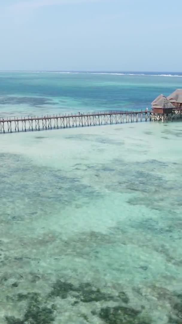 Vertical video house on stilts in the ocean on the coast of Zanzibar, Tanzania, air view — Stock video
