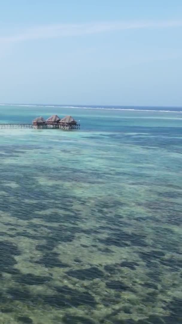 Vertical video house on stilts in the ocean on the coast of Zanzibar, Tanzania, air view — Stock video