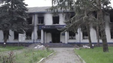 Bu stok videosu Ukrayna 'daki savaşın sonuçlarını gösteriyor. Borodyanka, Kyiv bölgesindeki polis karakolunun yıkılmış ve yanmış binası, gri, renksiz, düz.