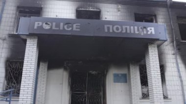 Bu stok videosu Ukrayna 'daki savaşın sonuçlarını gösteriyor. Borodyanka, Kyiv bölgesindeki polis karakolunun yıkılmış ve yanmış binası, gri, renksiz, düz.