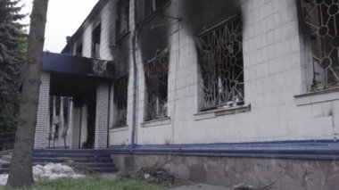 Bu stok videosu Ukrayna 'daki savaşın sonuçlarını gösteriyor. Borodyanka, Kyiv bölgesindeki polis karakolunun yıkılmış ve yanmış binası, gri, renksiz, düz.