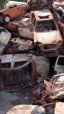 Bu stok dikey video Irpin, Bucha bölgesinde bir kurşun ve yanmış araba dökümü gösteriyor.