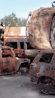 Bu stok dikey video Irpin, Bucha bölgesinde bir kurşun ve yanmış araba dökümü gösteriyor.