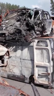 Bu stok dikey video Irpin, Bucha bölgesinde bir kurşun ve yanmış araba dökümü gösteriyor.