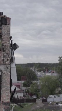 Bu borsa dikey videosu Stoyanka, Bucha bölgesinde, Ukrayna 'da, gri, renksiz, düz bir bina gösteriyor.