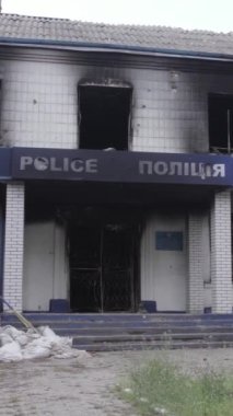 Bu dikey video Ukrayna 'daki savaşın sonucunu gösteriyor. Borodyanka, Kyiv bölgesindeki polis karakolunun yıkılmış ve yanmış binası. Gri, renksiz, düz.