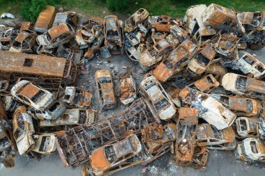 This stock photo shows a dump of shot and burned cars in Irpin, Bucha district clipart
