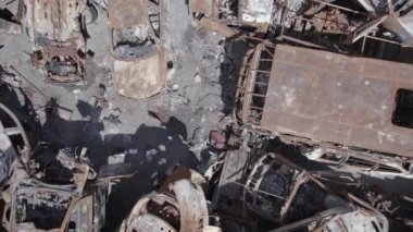 Bu video Irpin, Bucha bölgesinde, gri, düz, renksiz, yanmış arabaları gösteriyor.