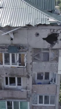 Bu dikey video Ukrayna 'daki savaş sırasında Makariv şehrinde yıkılmış bir binayı gösteriyor. Gri, renksiz, düz.