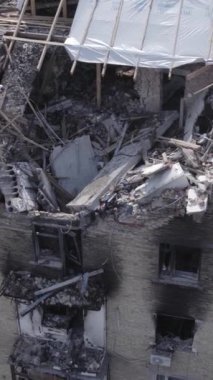 Bu dikey video Ukrayna 'daki savaş sırasında Makariv şehrinde yıkılmış bir binayı gösteriyor. Gri, renksiz, düz.