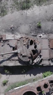 Bu stok dikey video Ukrayna 'daki yok olmuş askeri teçhizatın havadan görüntüsünü gösteriyor, gri, renksiz, düz.