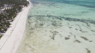 This stock video shows an aerial view of the ocean near the coast of Zanzibar, Tanzania, slow motionin in 8K resolution