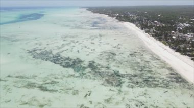 This stock video shows an aerial view of the ocean near the coast of Zanzibar, Tanzania, slow motionin in 8K resolution