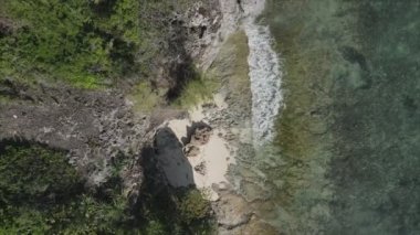 This stock video shows an aerial view of the ocean near the coast of Zanzibar, Tanzania, slow motionin in 8K resolution