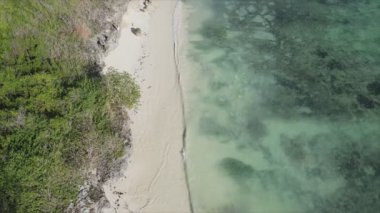 This stock video shows an aerial view of the ocean near the coast of Zanzibar, Tanzania, slow motionin in 8K resolution